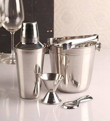 The set includes an ice bucket, a peg measure, a cocktail shaker, tongs, and a bottle opener.