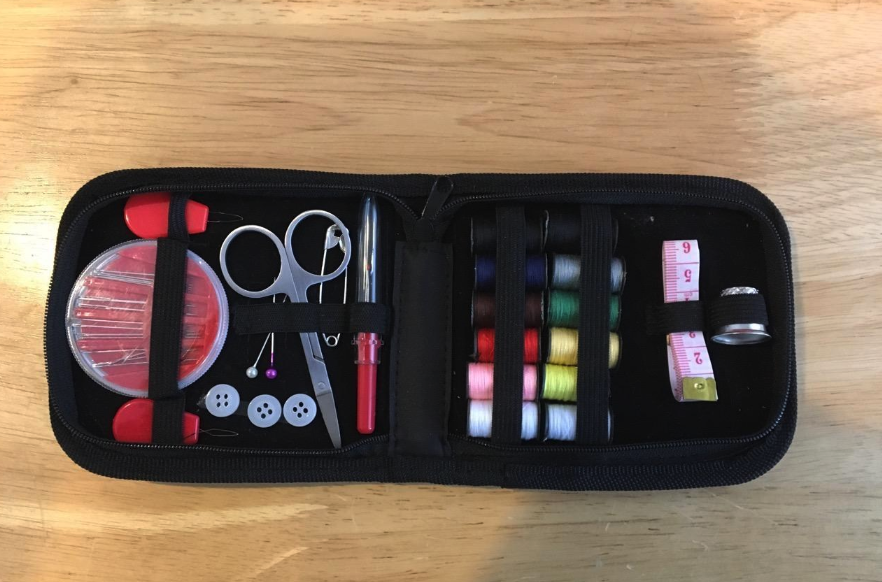 Reviewer image of the sewing kit open and displayed on a table showing the contents