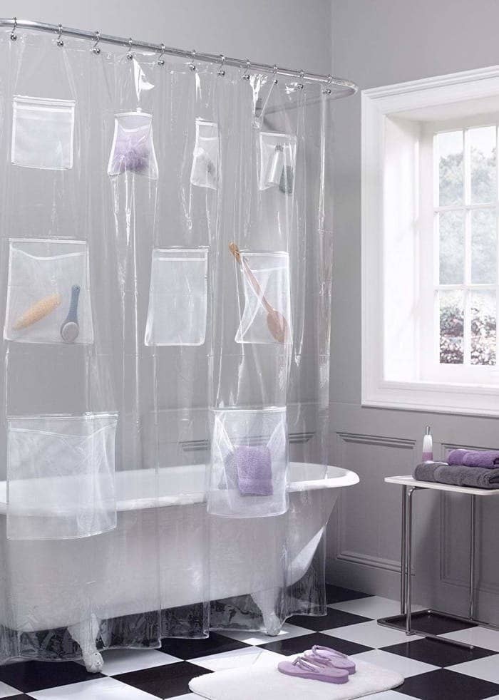 the shower curtain with bath accessories stored in the pockets 