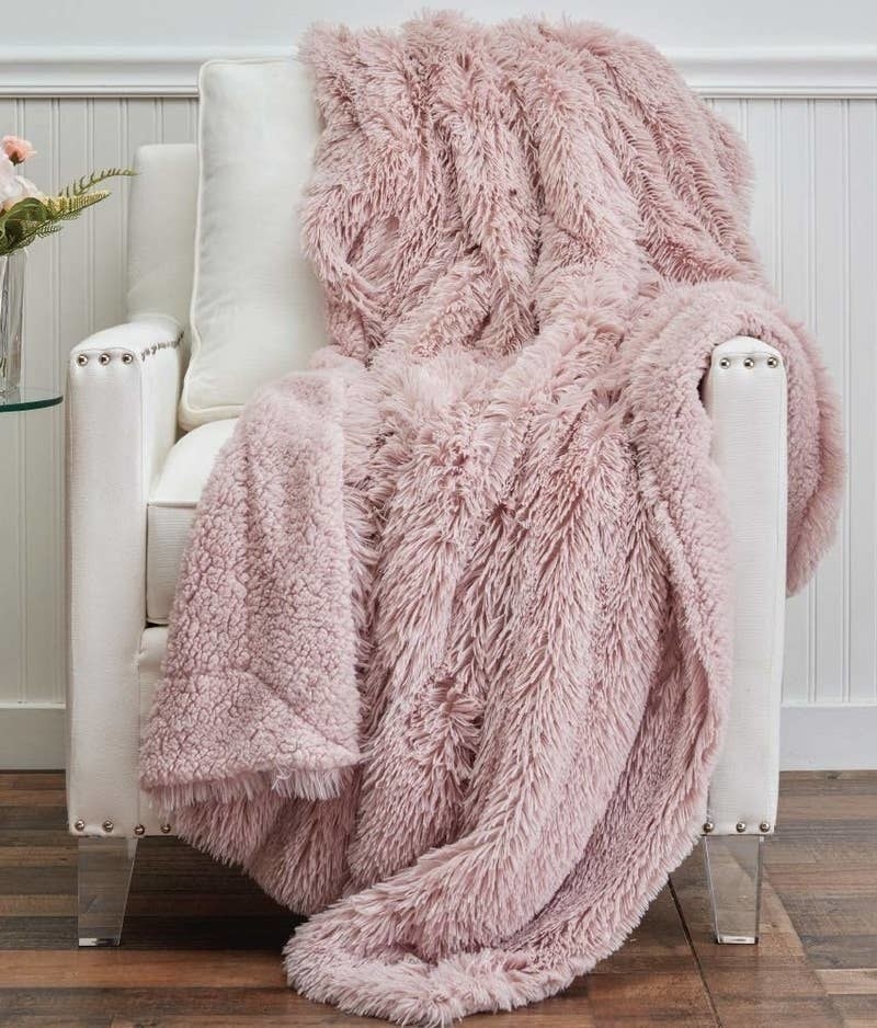 The throw blanket with long shaggy faux fur on one side and sherpa on the other side