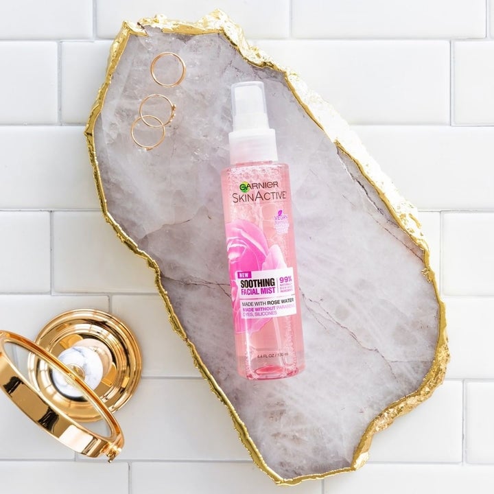 the Garnier face mist bottle displayed on a slab of crystal