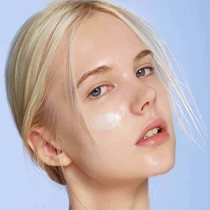 Model wearing the cream on their cheek