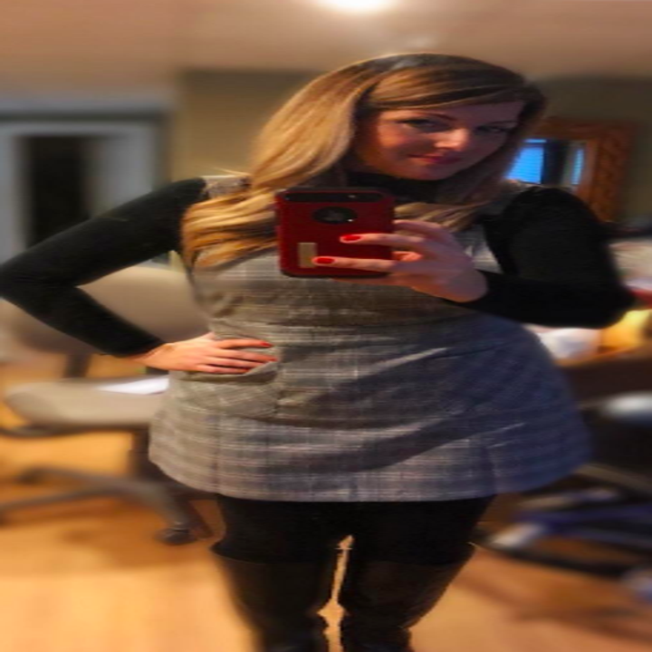 A reviewer wearing it in gray plaid