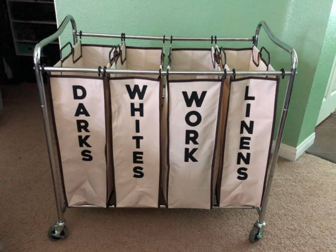 a reviewer photo of the cart broken into four sections, &quot;darks, whites, work, and linens&quot;