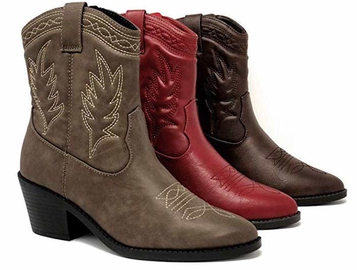 three cowboy boots that come up just above the ankle but just below the calves. They ahv a pointed toe and embroider on the side. The three boots are brown, deep brown, and red.