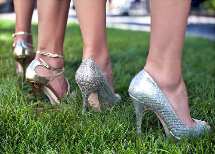 A group of people wearing highheels in grass