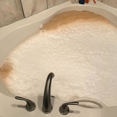 Reviewer's hot tub filled with dirty brown water that's been cleaned out of the jets