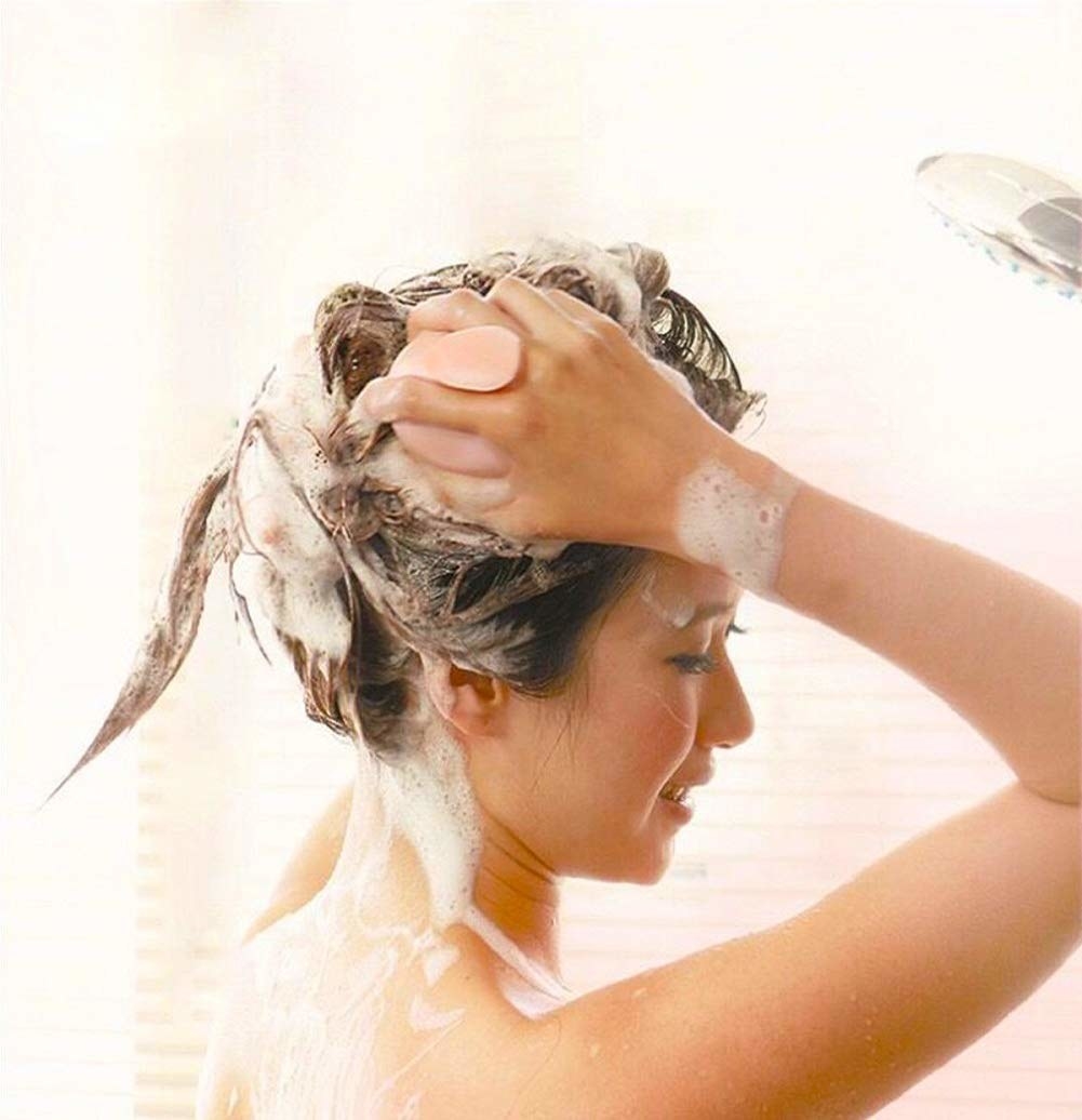 a model using the brush in the shower