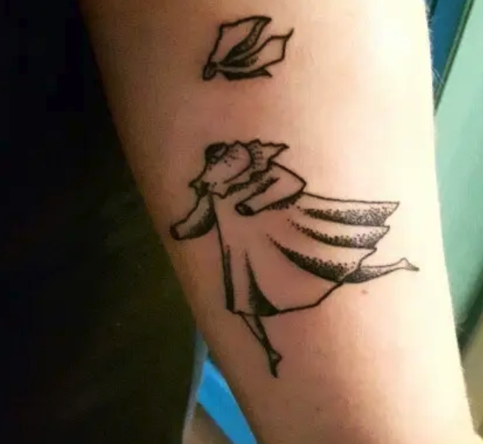 An arm tattoo of the inviisble child from &quot;Tales from Moominvalley&quot;