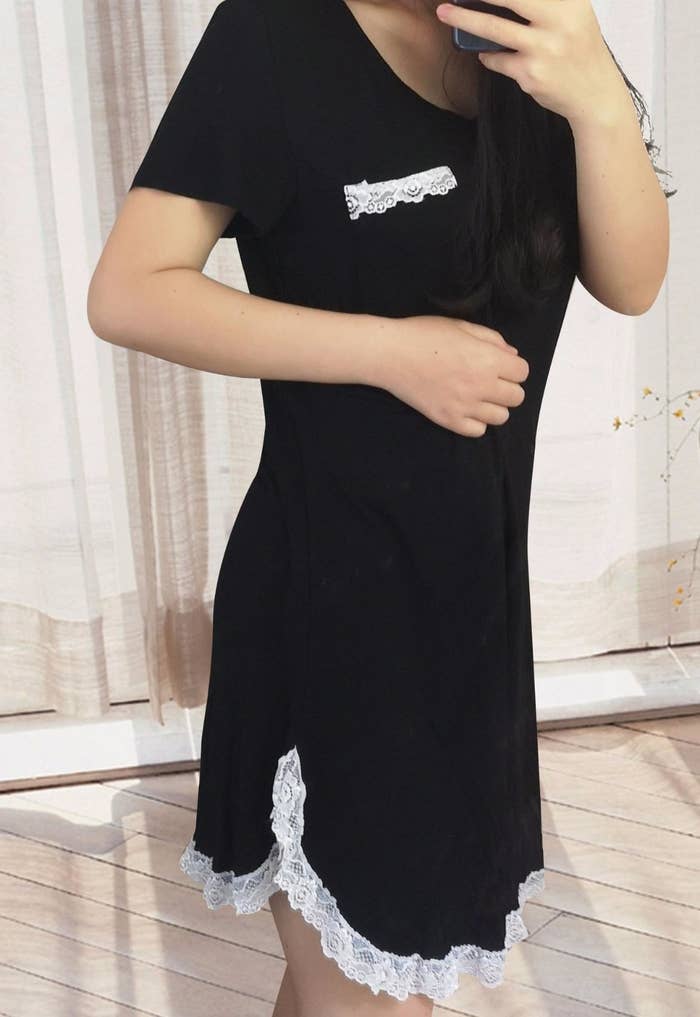 model in black t-shirt nightgown with white lace trim and a chest pocket