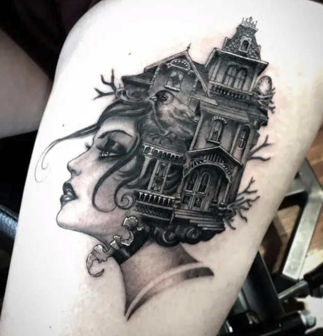 A tattoo of a woman&#x27;s head with a house coming out of her hair
