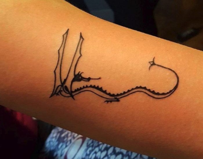 An arm tattoo of Smaug
