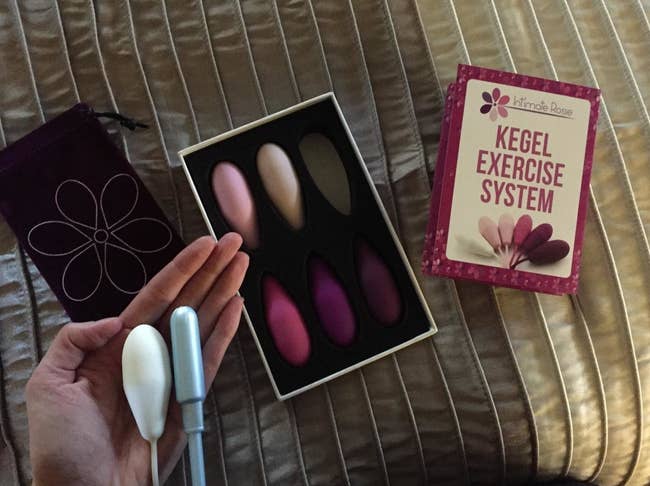 Reviewer holding one of the weights, which is similar in size to a tampon