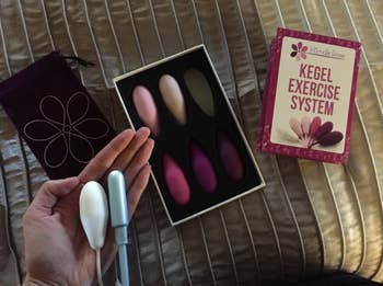 Reviewer holding one of the weights, which is similar in size to a tampon