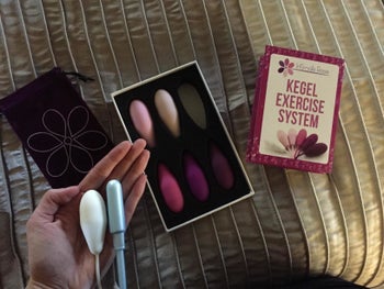 Reviewer holding one of the weights, which is similar in size to a tampon