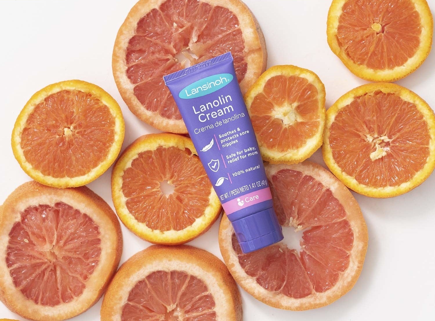 bottle of the nipple cream on a bed of orange slices