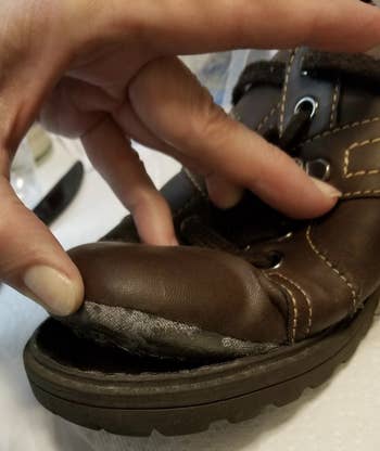 a reviewer's boot with the sole near the toe coming apart 