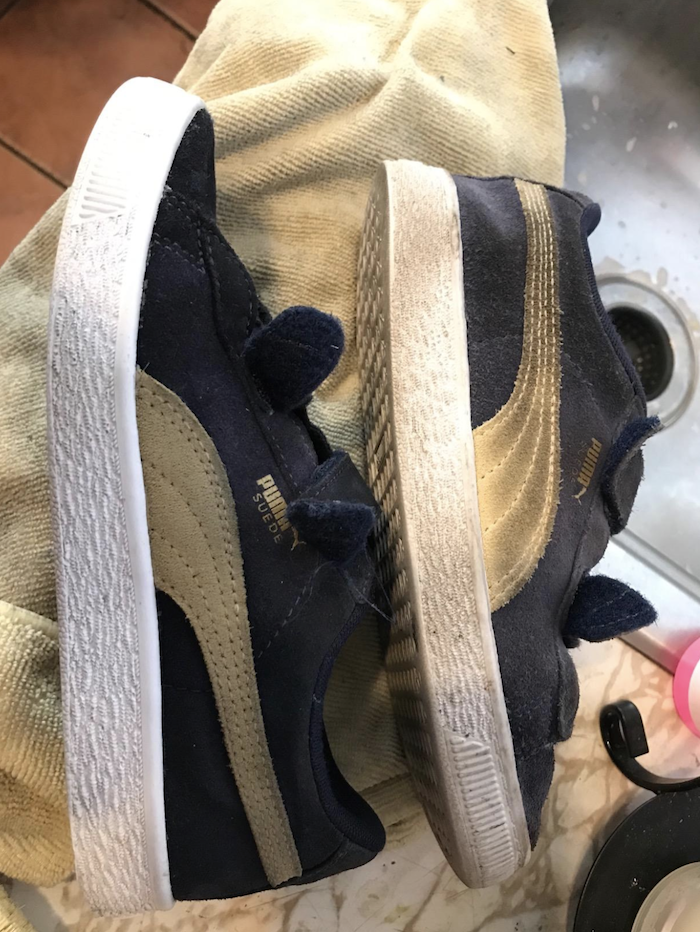 two pairs of Puma sneakers. One is dirty and one is sparkling clean and looks like a brand new sneaker.