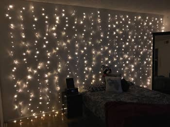 twinkle lights layered down the walls of a reviewer's bedroom