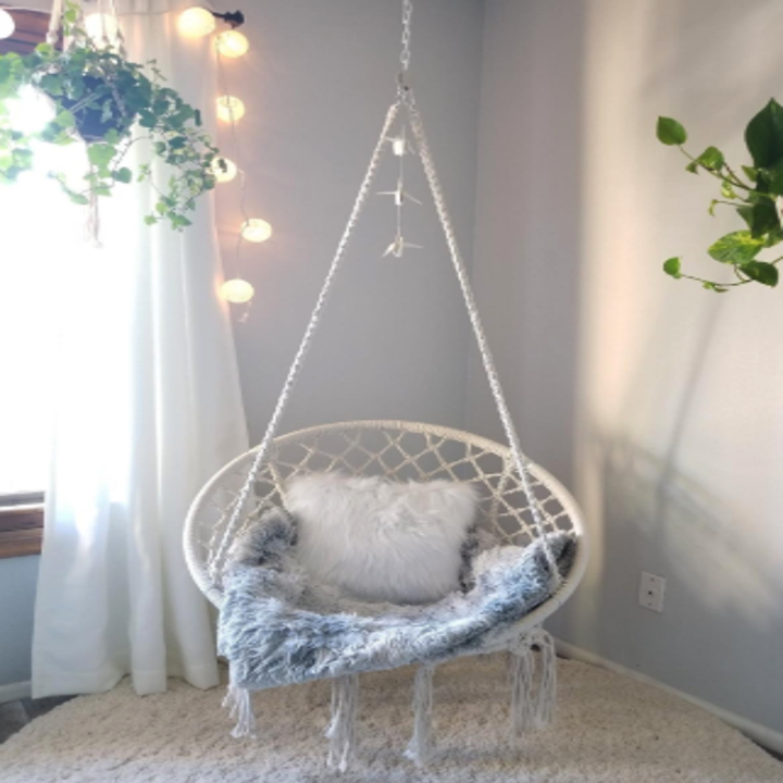 a reviewer's white macrame swing hanging in a corner