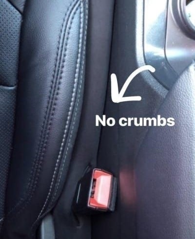 The gap stopper in a reviewer&#x27;s car with an arrow and &quot;no crumbs&quot;