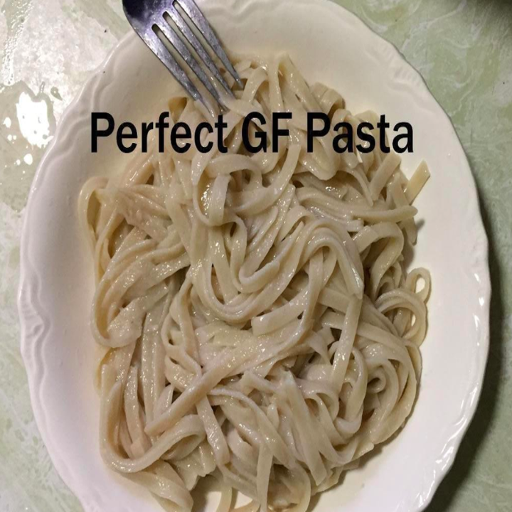 A reviewer showing a plate of cooked pasta noodles