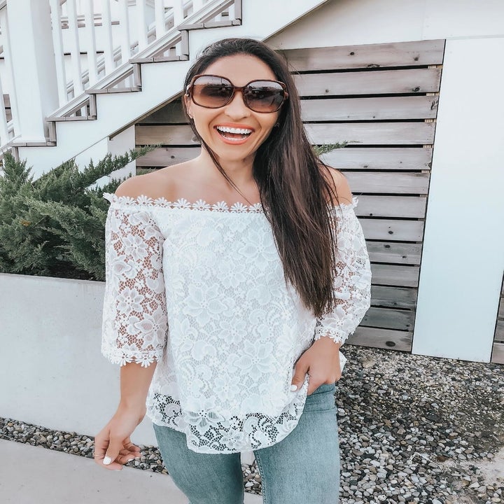 reviewer wears off the shoulder top with lace sleeves