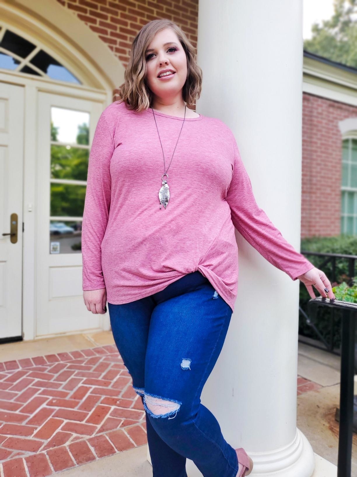 reviewer wears heather pink long sleeve with tucked knotted front 