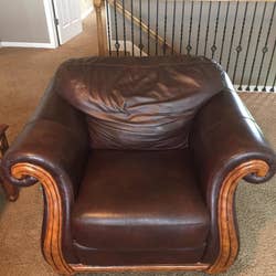 The same armchair looking new in a rich dark brown after the balm was used