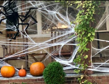 Porch covered in fake spider web decorations