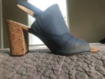 Before photo of blue suede heels with watermarks and stains around the toe