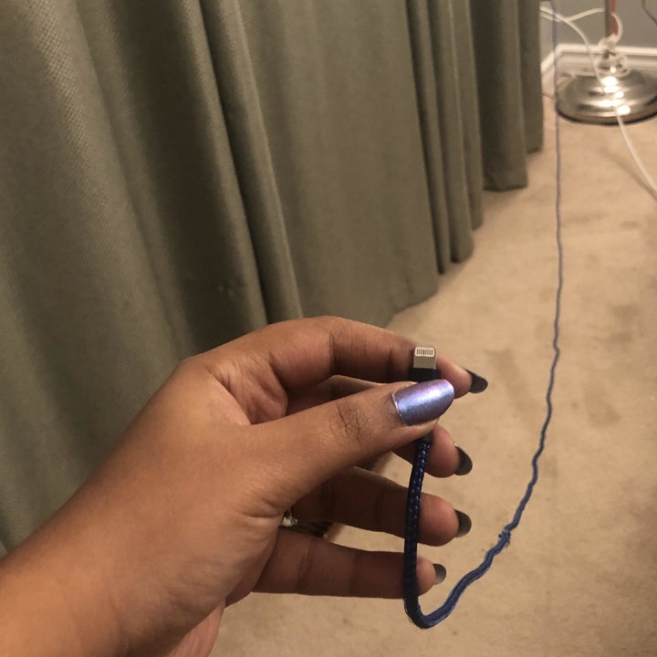 A person holding a braided lighting charger