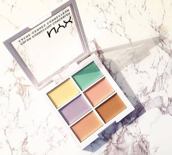 The palette with yellow, green, purple, peach, pink, and brown color correctors