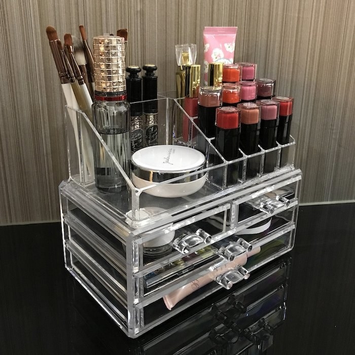 The clear acrylic organizer with drawers on the bottom and shelves on top 