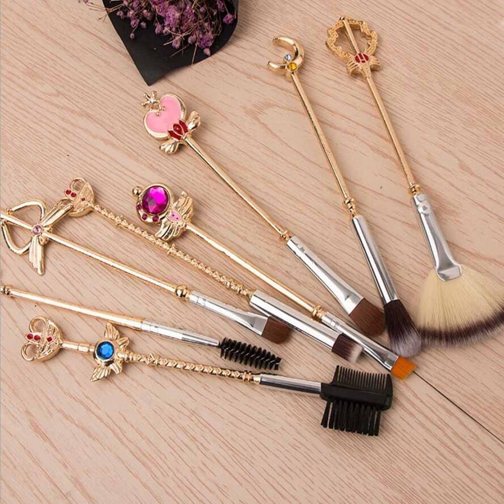 A set of Sailor Moon brushes laid out on a table next to flowers