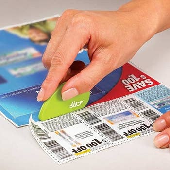 Hand using slicer to cut coupons
