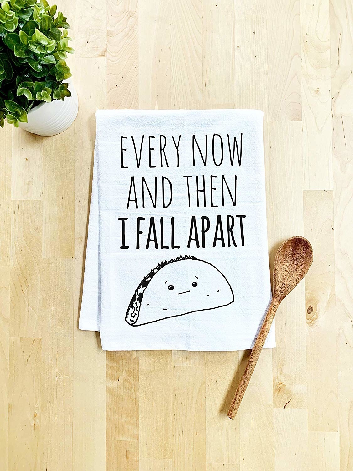 The towel which reads, &quot;Every now and then I fall apart&quot; with an image of a hard shell taco