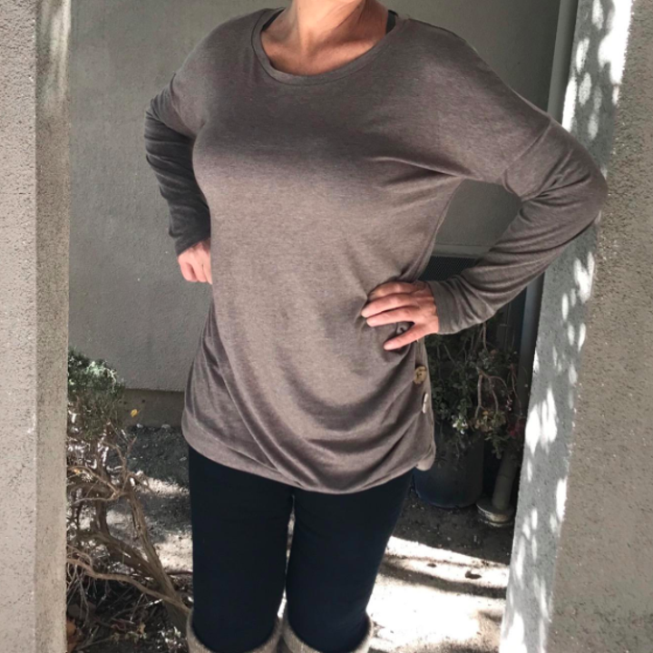 A reviewer wearing the shirt in brown