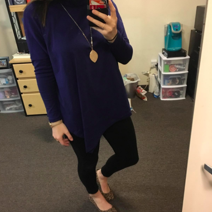 A reviewer wearing the top in blue