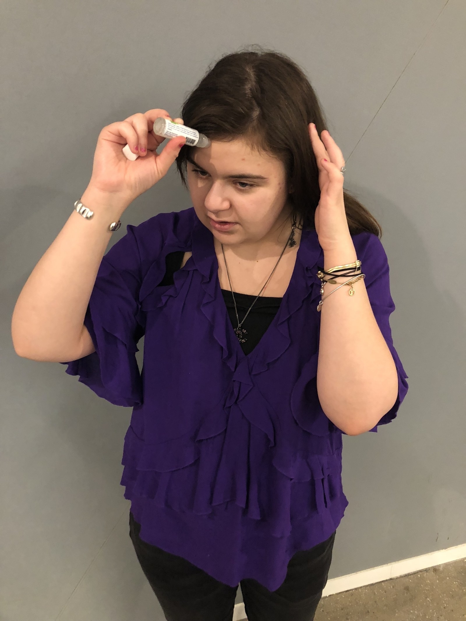 BuzzFeed writer holding the stick to her forehead