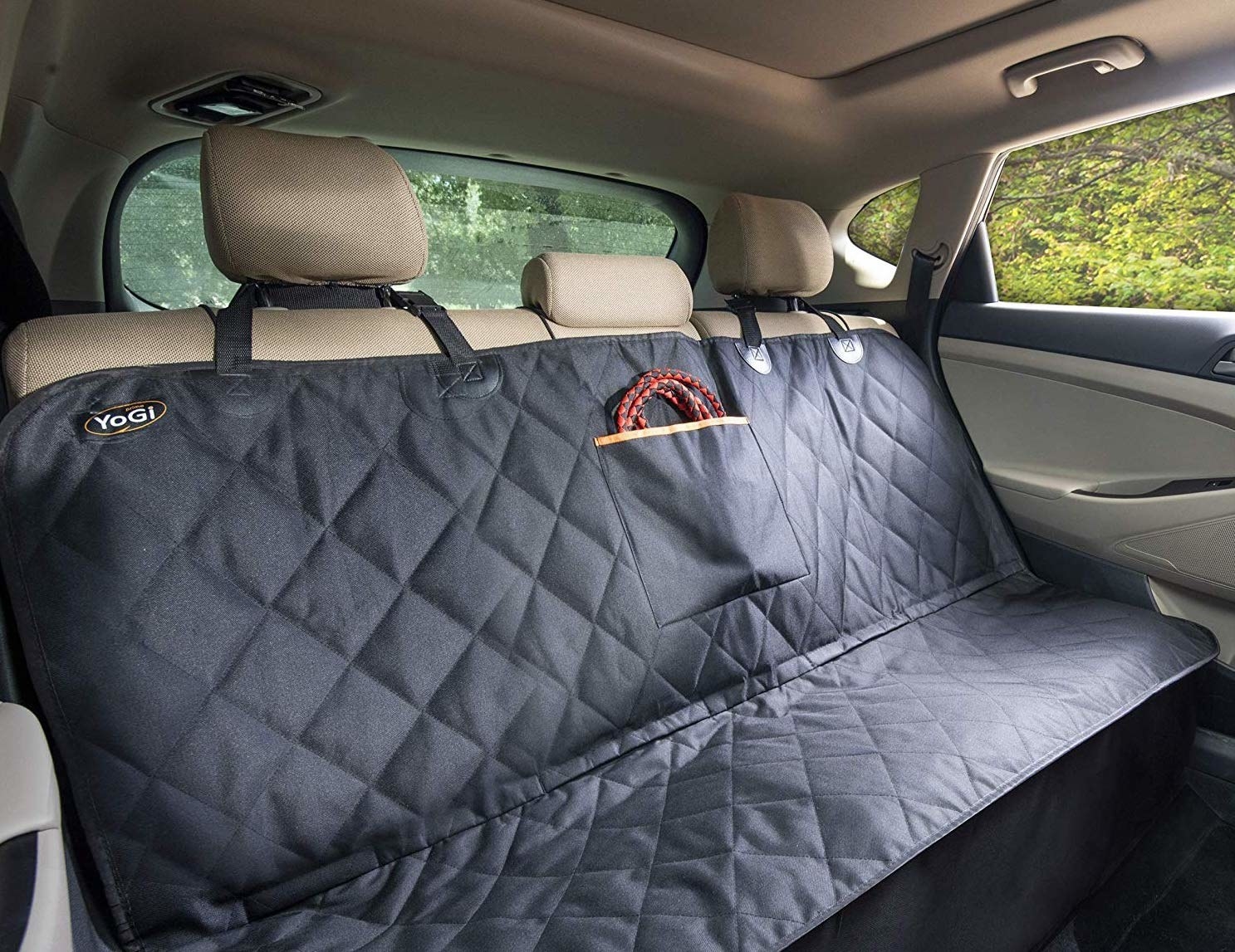 The backseat of a car with the car seat-cover on it