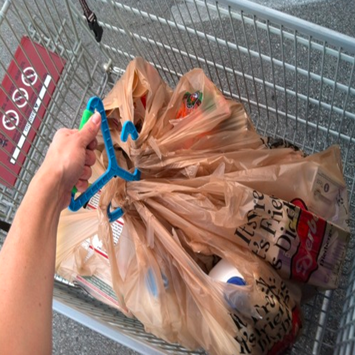 a person holding many bags on the handle