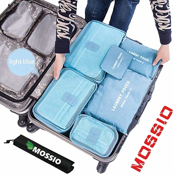 the blue packing cubes neatly stacked in a suitcase