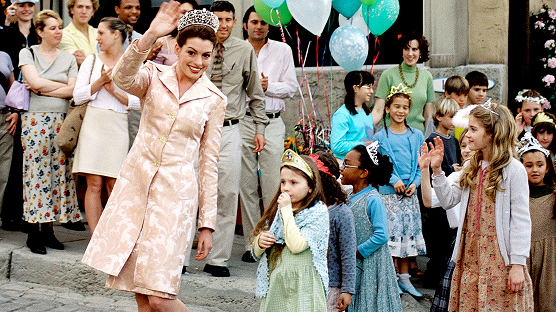 Anne Hathaway walks in a parade with Abigail Bresline
