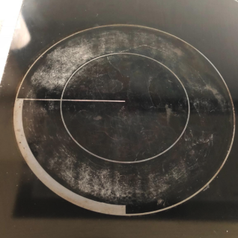 a reviewer's stove top looking scratched up with burnt-on grease