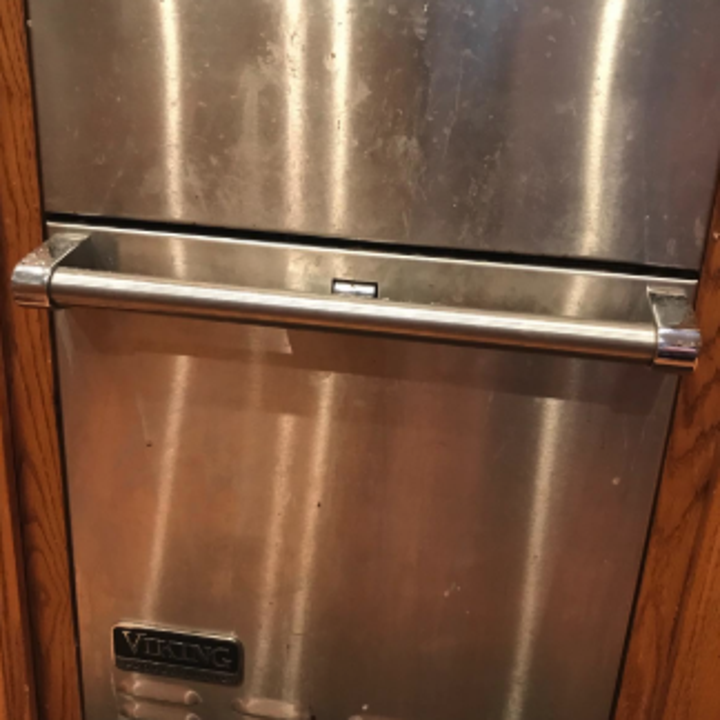 a reviewer's stacked stainless steel oven covered in finger prints