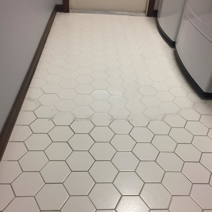 reviewer's tile floor with half of it showing dirt between the tiles and the other part with it looking clean and white between the tiles 