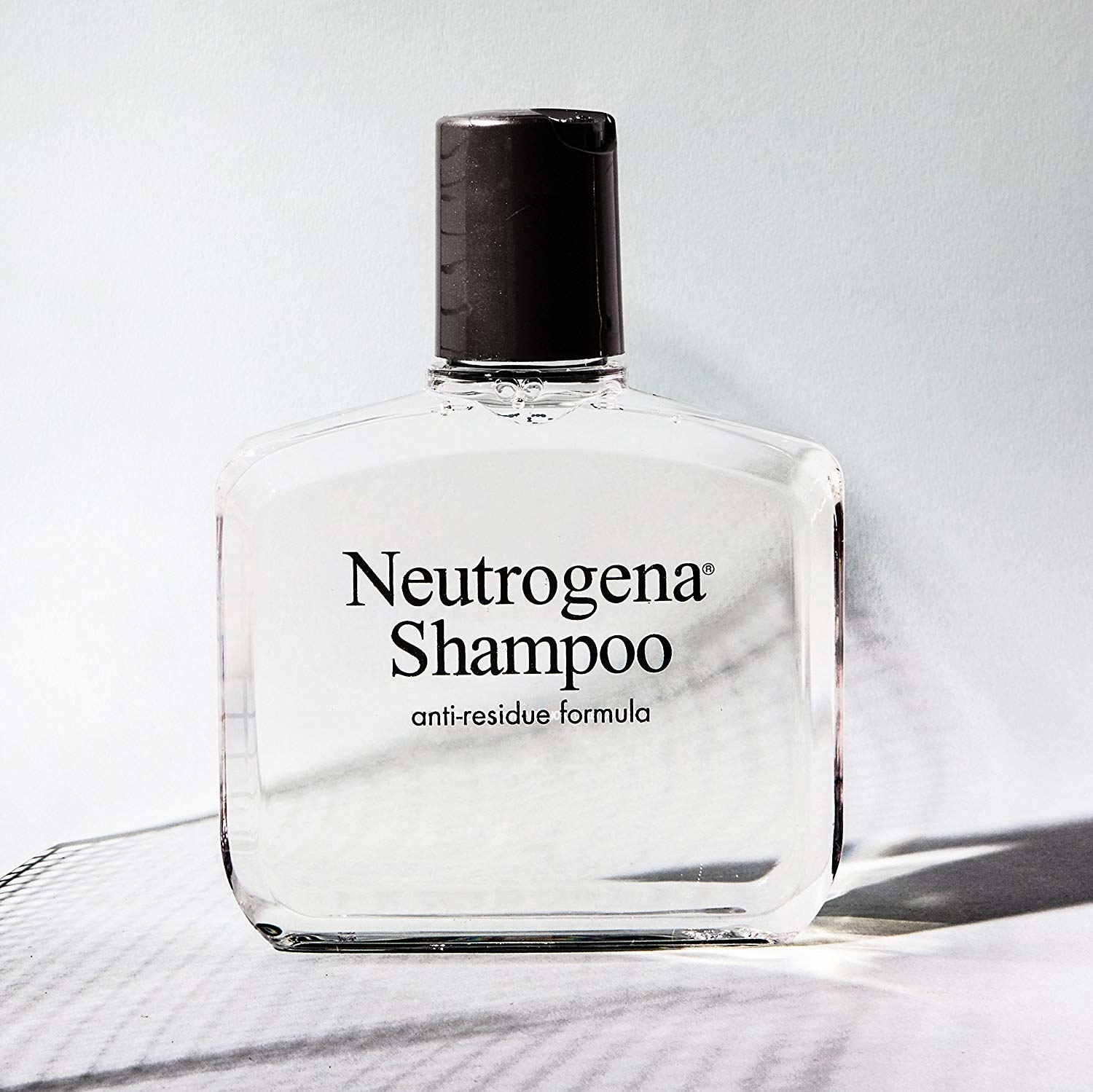 A bottle of shampoo on a simple countertop