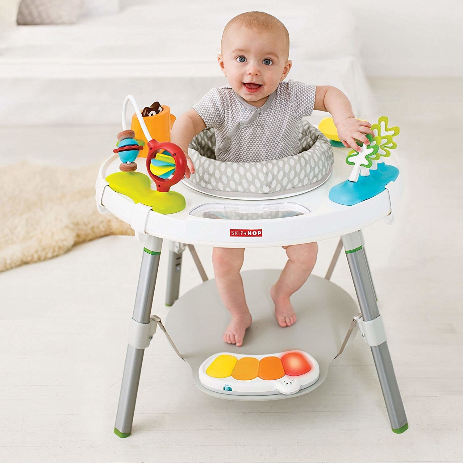 a baby in a skip hop play center