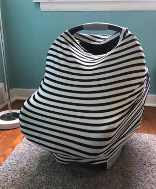 a striped baby seat cover over a car seat